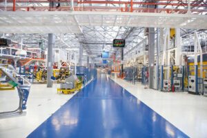 A factory floor with blue and white paint, creating a vibrant and clean environment for production.