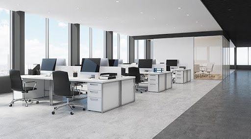 An image of a clutter-free office with a desk, shelf, and two chairs.