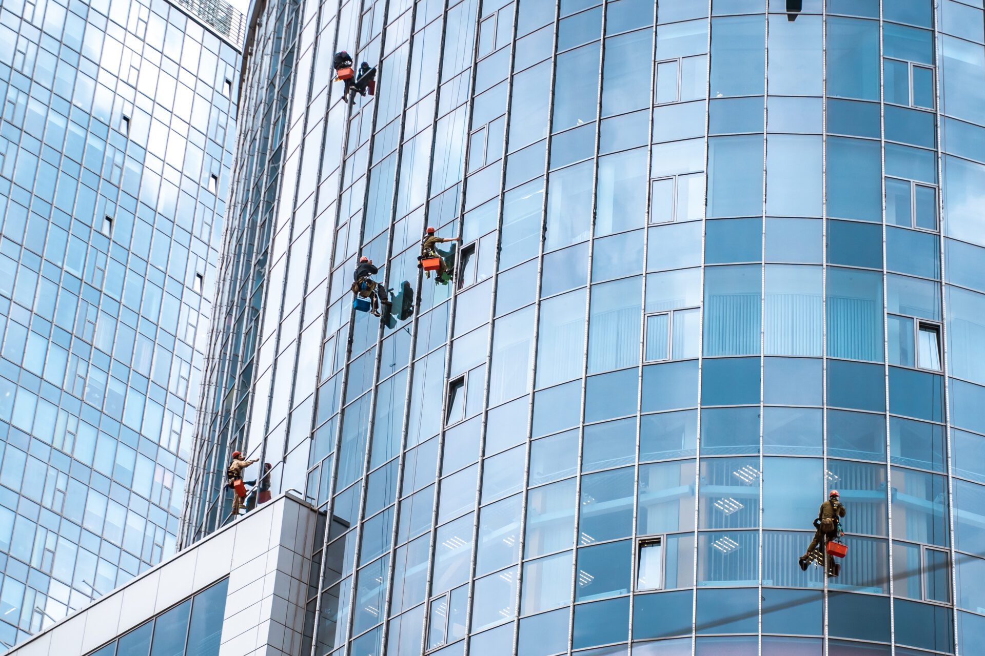 Workers washing windows in the office building