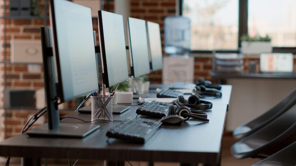 A clean and organized office desk with computers.